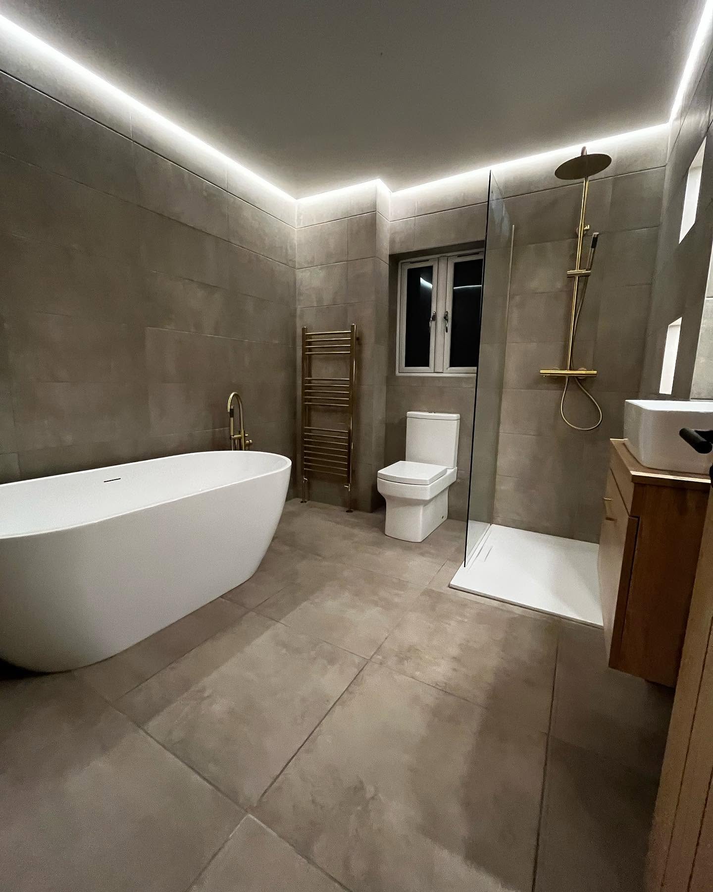 Completed luxury bathroom suite with brass fittings